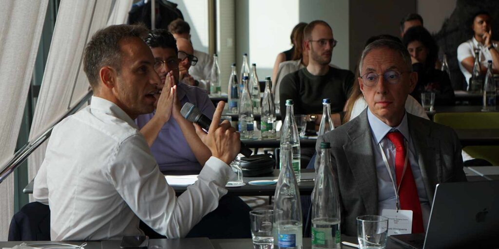 Emilio Torres-Netto speaking on a microphone at the ELZA refractive surgery course 2023